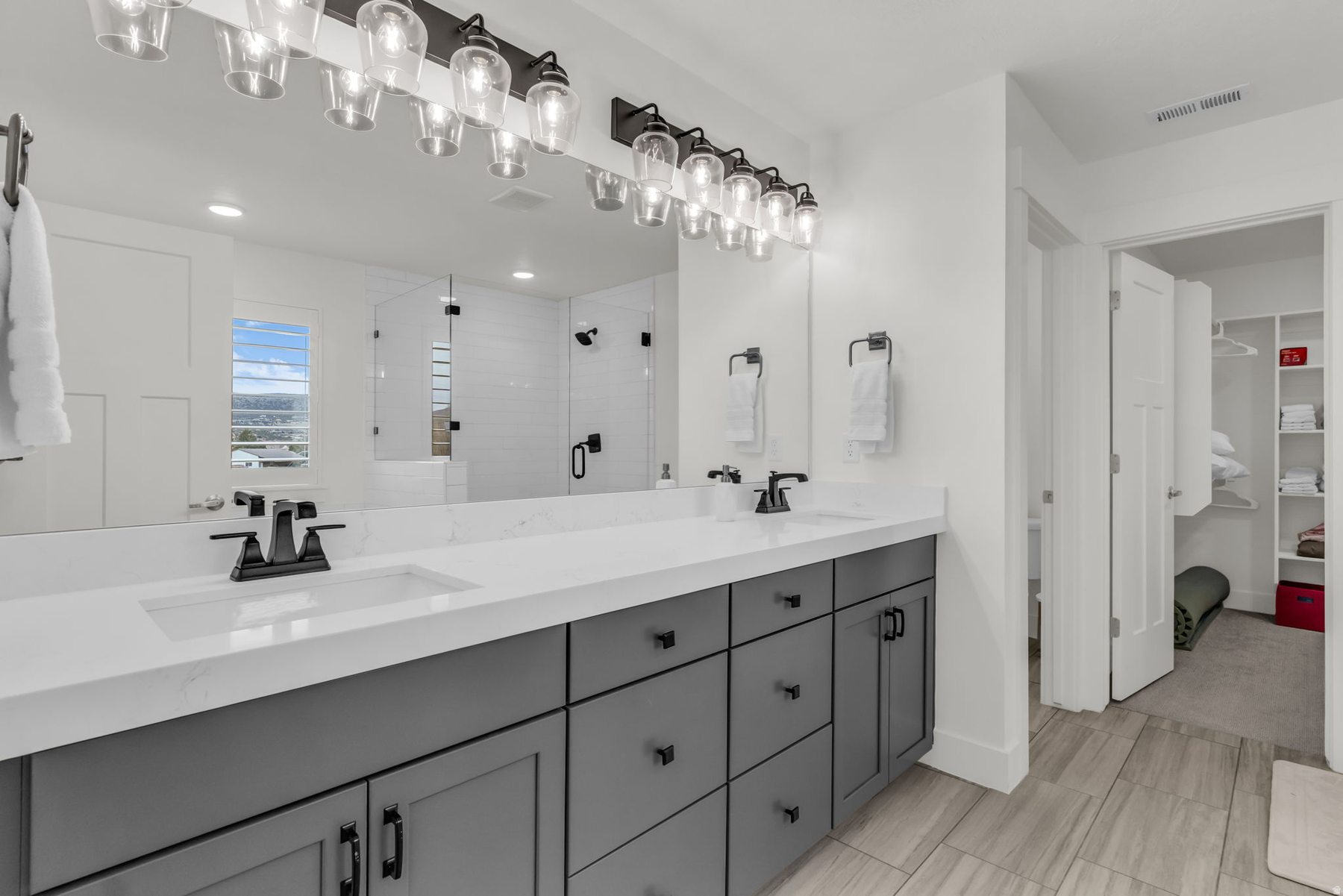 Master bathroom dual vanity at 1243 S 1040 E with quartz counters black hardware and walk-in closet